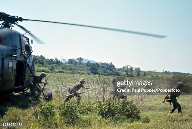 Marines of the 3rd Marine Division leaving a helicopter under fire in Da Nang, Vietnam, circa April 1965.