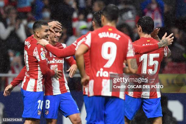 Atletico players celebrate Betis' owngoal during the Spanish League football match between Club Atletico de Madrid and Real Betis at the Wanda...