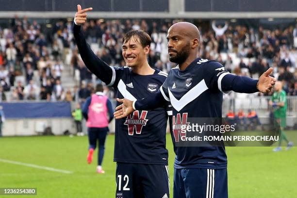 Bordeaux' French forward Jimmy Briand celebrates after scoring a goal with Bordeaux's Portuguese defender Ricardo Mangas during the French L1...