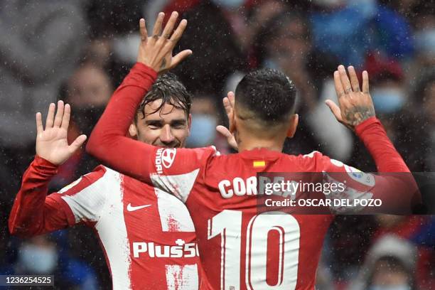 Atletico Madrid's French forward Antoine Griezmann and Atletico Madrid's Argentine forward Angel Correa celebrate Betis' owngoal during the Spanish...