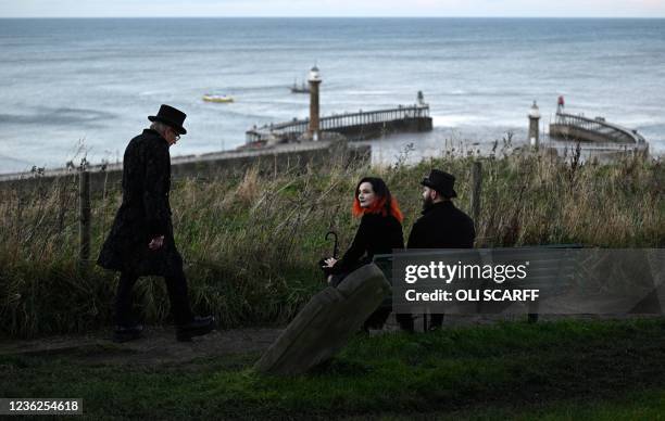 Participants in costume attend the biannual 'Whitby Goth Weekend' festival in Whitby, northern England, on October 31, 2021. The festival brings...