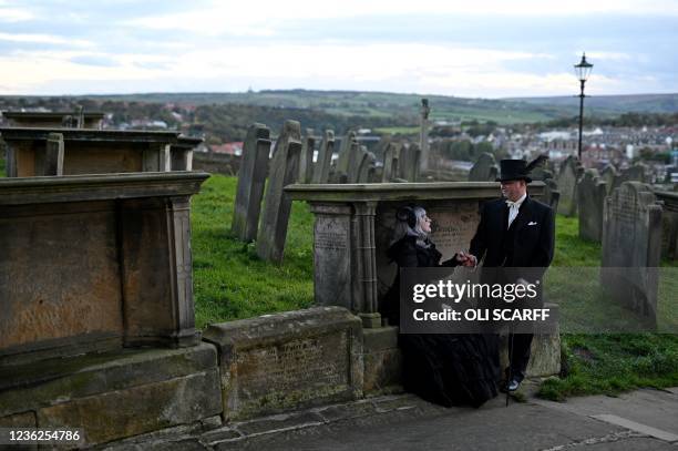 Participants in costume attend the biannual 'Whitby Goth Weekend' festival at St Mary the Virgin's Church in Whitby, northern England, on October 31,...