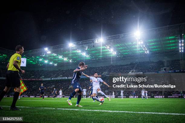 Ramy Bensebaini of Mönchengladbach safes a ball against Konstantinos Stafylidis of Bochum during the Bundesliga match between Borussia...