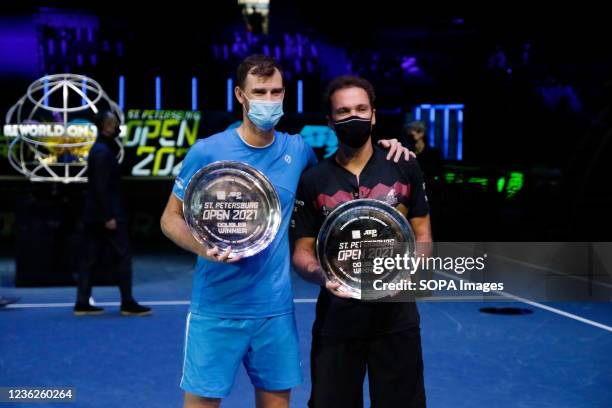 Jamie Murray of Great Britain and Bruno Soares of Brazil pose with their awards during the award ceremony for the winners of the final doubles match...