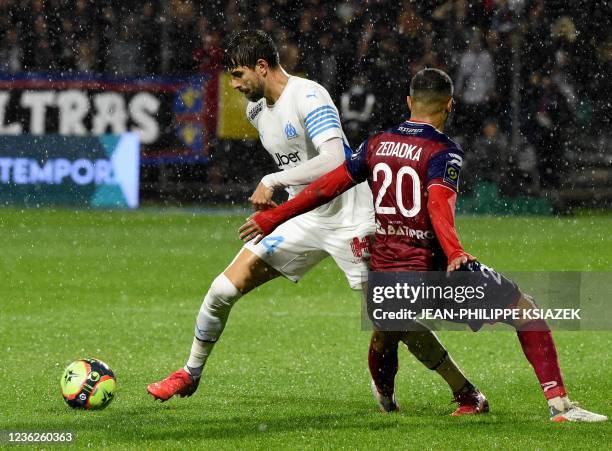 Marseille's Brazilian defender Luan Peres Petroni fights for the ball with Clermont's French defender Akim Zedadka during the French L1 football...