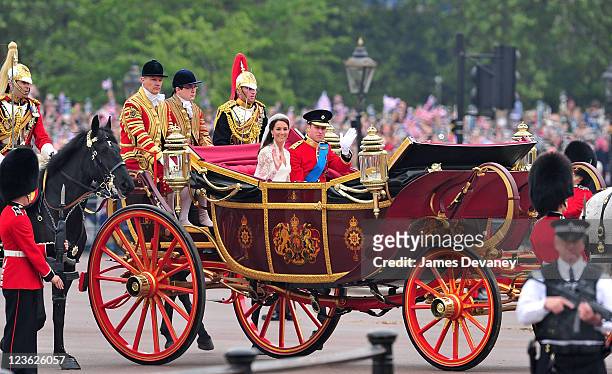 Prince William, Duke of Cambridge and Catherine, Duchess of Cambridge greet crowd of admirers while arriving to Buckingham Palace on April 29, 2011...