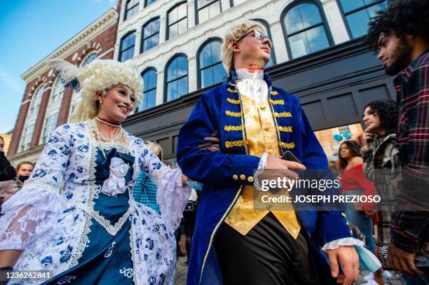 Costumed revellers walk the streets on Halloween in Salem, Massachusetts on October 31, 2021. - The city is the location of the witch trials that...