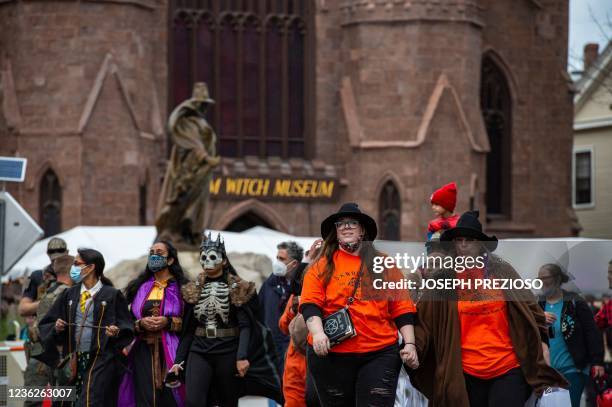 Costumed revellers fill the streets, with the Salem Witch Museum in the background, on Halloween in Salem, Massachusetts on October 31, 2021. - The...