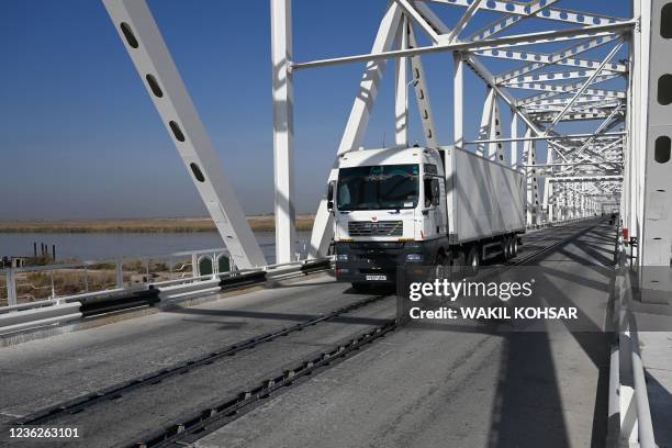 This picture taken on October 27, 2021 shows a truck arriving from Uzbekistan at the Afghanistan-Uzbekistan Friendship Bridge in Hairatan, about 82...