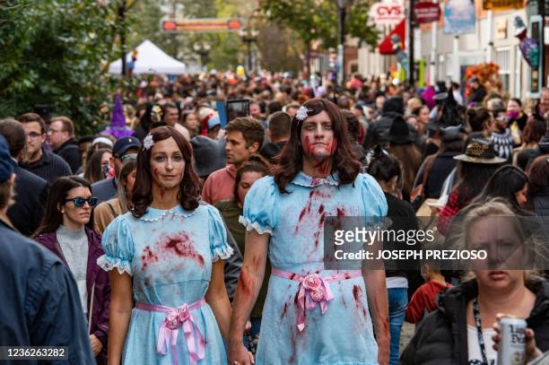 Revellers walk the streets on Halloween in Salem, Massachusetts on October 31, 2021. - The city is the location of the witch trials that took place...