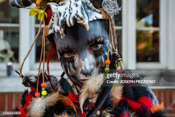 Reveller dressed in a Voodoo outfit poses on Halloween in Salem, Massachusetts on October 31, 2021. - The city is the location of the witch trials...