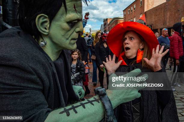 Gail DiSabatino Showghi gets a scare from Frankenstein's monster on Halloween in Salem, Massachusetts on October 31, 2021. - The city is the location...