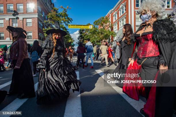 Zoraima Munoz , of Long Beach California, crosses the street dressed as a witch on Halloween in Salem, Massachusetts on October 31, 2021. - The city...