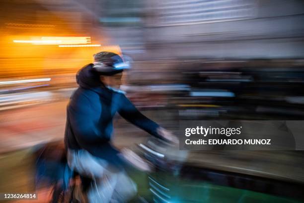 Delivery worker rides his bike in the Manhattan borough of New York on October 27, 2021. - "A colleague needs help to recover his bicycle!" says a...