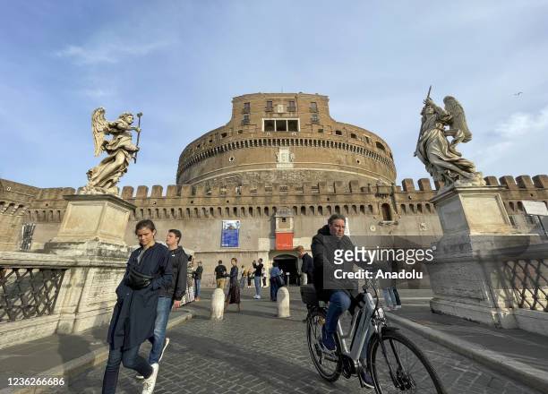 View of Mausoleum of Hadrian and St. Angelo Bridge as people visit in Rome, Italy on October 31, 2021.