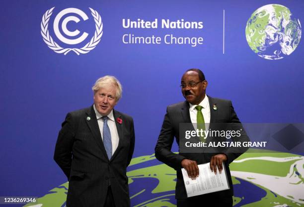 Britain's Prime Minister Boris Johnson greets Antigua and Barbuda's Prime Minister Gaston Alfonso Browne as they arrive to attend the COP26 UN...