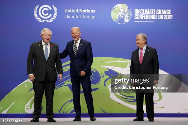 British Prime Minister Boris Johnson and UN Secretary-General Antonio Guterres greet U.S. President Joe Biden as they arrive for day two of COP26 at...