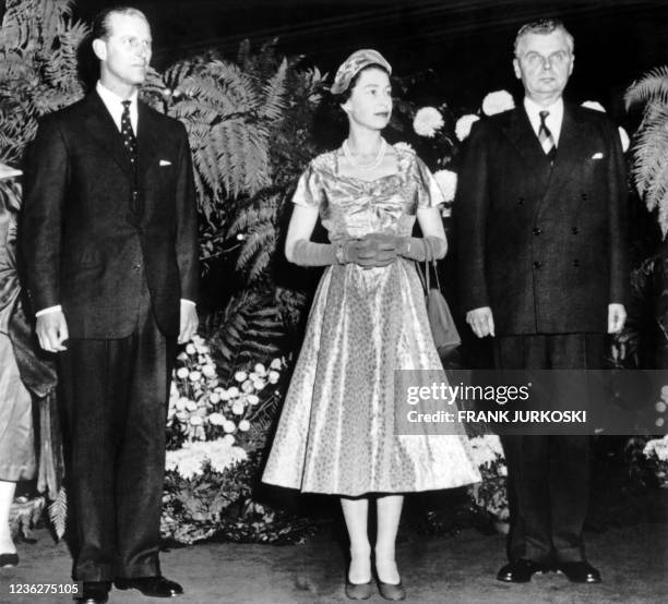 Queen Elizabeth II flanked by Prince Philip, Duke of Edinburgh and Canadian Prime Minister John Diefenbaker attends a reception at Château Laurier in...