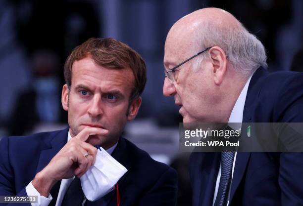 Lebanese Prime Minister Najib Mikati speaks with French President Emmanuel Macron during the opening ceremony of the UN Climate Change Conference...