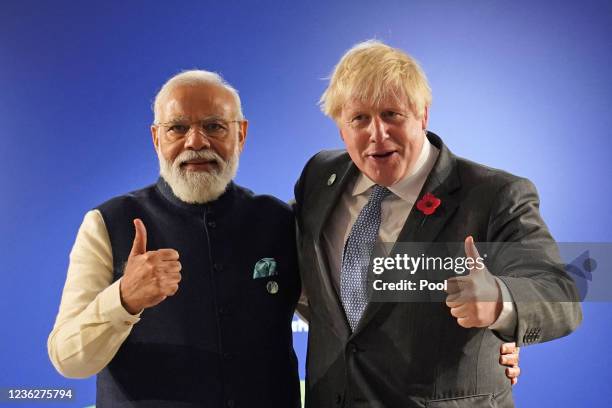 British Prime Minister Boris Johnson greets India's Prime Minister Narendra Modi ahead of their bilateral meeting during the Cop26 summit at the...