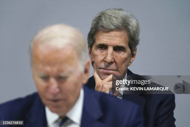 Climate Adviser John Kerry listens to U.S. President Joe Biden delivering a speech as they attend a meeting focused on action and solidarity at the...