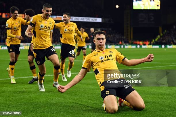 Wolverhampton Wanderers' English defender Max Kilman celebrates after scoring the opening goal during the English Premier League football match...