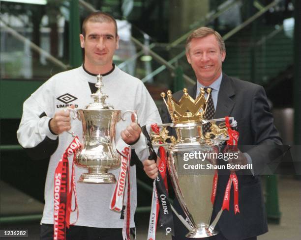 12th May 1996; Manchester United manager Alex Ferguson and Eric Cantona with the FA Cup and Premiership trophy on their arrival at Manchester's...