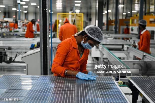 In this photo taken on October 13 an employee connects solar cells at the Vikram Solar manufacturing plant in Oragadam, in the southern Indian state...