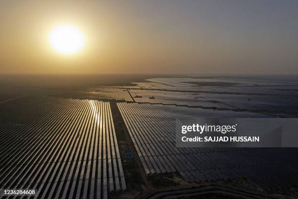 This photo taken on October 6, 2021 shows solar panels at the site of solar energy projects developer Saurya Urja Company of Rajasthan Limited, at...