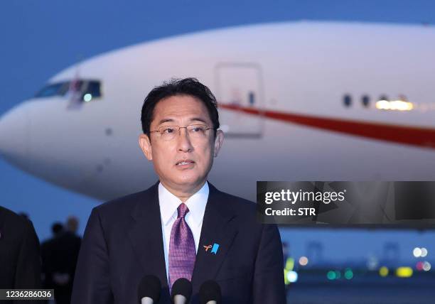Japan's Prime Minister Fumio Kishida speaks to reporters as he departs from Tokyo's Haneda airport on November 2 for the World Leaders' Summit of the...