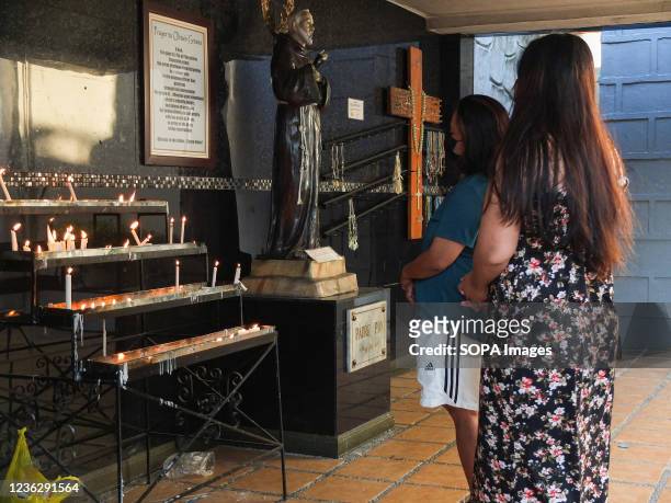 Devotees pray for their departed relatives after lighting candles. The Philippine Government task force against Covid-19 ordered the public and...