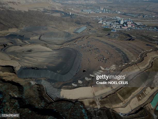 This aerial view shows coal being loaded onto trucks near a coal mine in Datong, China's northern Shanxi province on November 2, 2021.