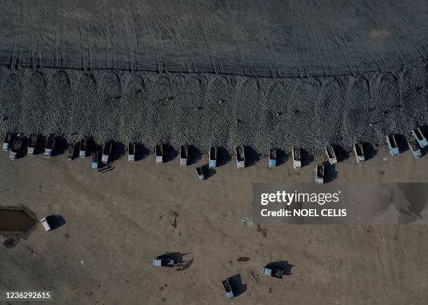 This aerial view shows coal being loaded onto trucks near a coal mine in Datong, China's northern Shanxi province on November 2, 2021.