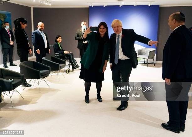 Member of the delegation takes a selfie with British Prime Minister Boris Johnson , prior to a meeting with Israel's Prime Minister Naftali Bennett...