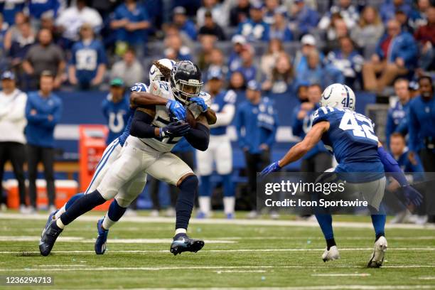 Tennessee Titans Running Back Derrick Henry carries the ball as Indianapolis Colts Cornerback Xavier Rhodes jumps on his back while Indianapolis...