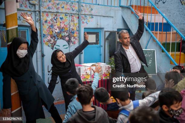 Founder and school principal of the Afghan Farhang school, Nader Mousavi Afghan female teachers Roghayeh Hasani and Fatemeh Hosseini exercise with...