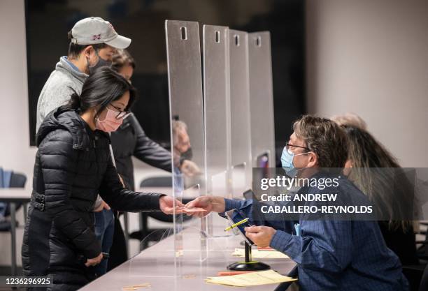 Voters register to cast ballots on election day at the Fairfax County Government Center polling location in Fairfax, Virginia, on November 2, 2021.