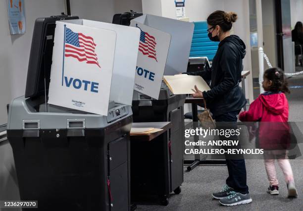 Voters cast ballots on election day at the Fairfax County Government Center polling location in Fairfax, Virginia, on November 2, 2021.