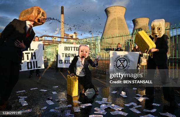 Oil Heads, climate activists from the Ocean Rebellion group, demonstrate outside the INEOS intergrated refinery and petrochemicals centre plant in...