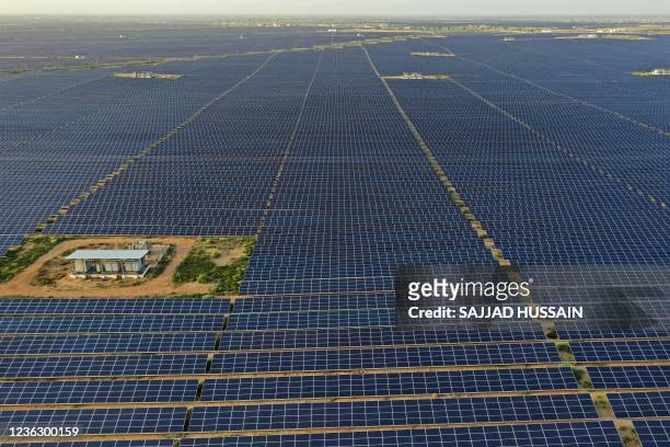 This photo taken on October 6, 2021 shows solar panels at the site of solar energy projects developer Saurya Urja Company of Rajasthan Limited, at...
