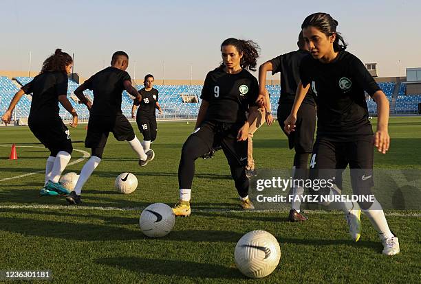 Players of the first Saudi Women's National Football Team, managed by veteran German Monika Staab, attend a training and show off their skills at...