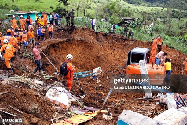 Emergency workers look for survivors after a mudslide buried two houses in Mallama, Narino province, Colombia, on November 2, 2021. - At least 4...