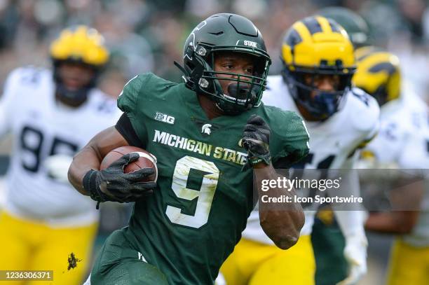 Michigan State Spartans running back Kenneth Walker breaks past the defense en route to the end zone during a college football game between the...