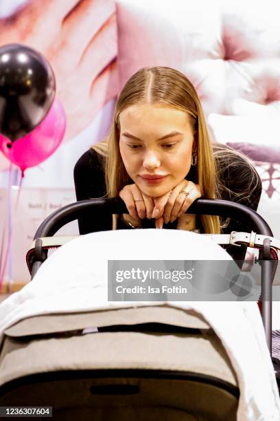 Model Cheyenne Savannah Ochsenknecht with her baby attend the Natascha Ochesenknecht N.O store opening on November 2, 2021 in Berlin, Germany.