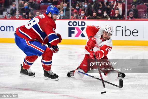 Robby Fabbri of the Detroit Red Wings controls the puck as he falls near David Savard of the Montreal Canadiens during the third period at Centre...