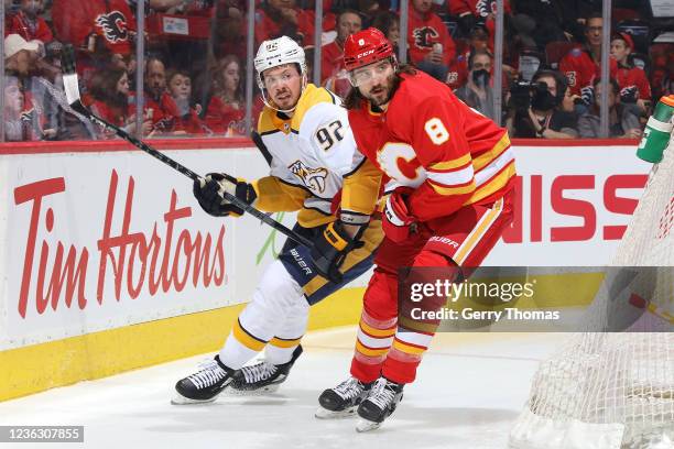 Christopher Tanev of the Calgary Flames battles against Ryan Johansen of the Nashville Predators at Scotiabank Saddledome on November 2, 2021 in...