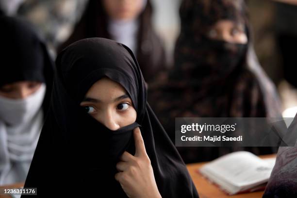 Afghan girls attend a class at a school in Farah, Afghanistan during the Taliban takeover of control of Afghanistan nearly two decades after they...