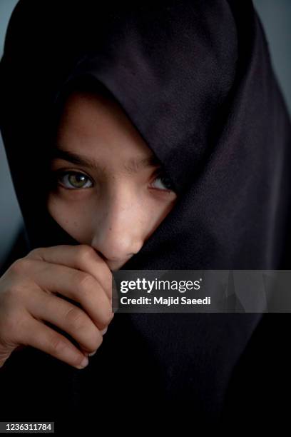 Afghan girl attend a class at a school in Farah, Afghanistan during the Taliban takeover of control of Afghanistan nearly two decades after they were...