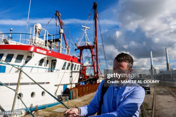 Fisherman from the British trawler "Cornelis-Gert Jan Dumfries" arrives at his boat docked and waiting to be given permission to leave the northern...