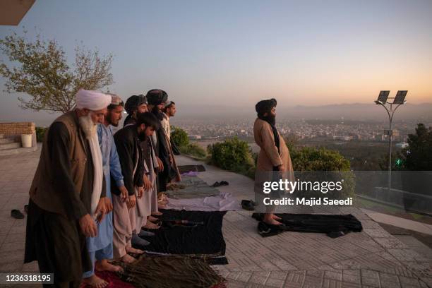 Taliban members pray at a public promenade in western Herat, on October 7, 2021 in Herat, Afghanistan. The Taliban regained control of Afghanistan...